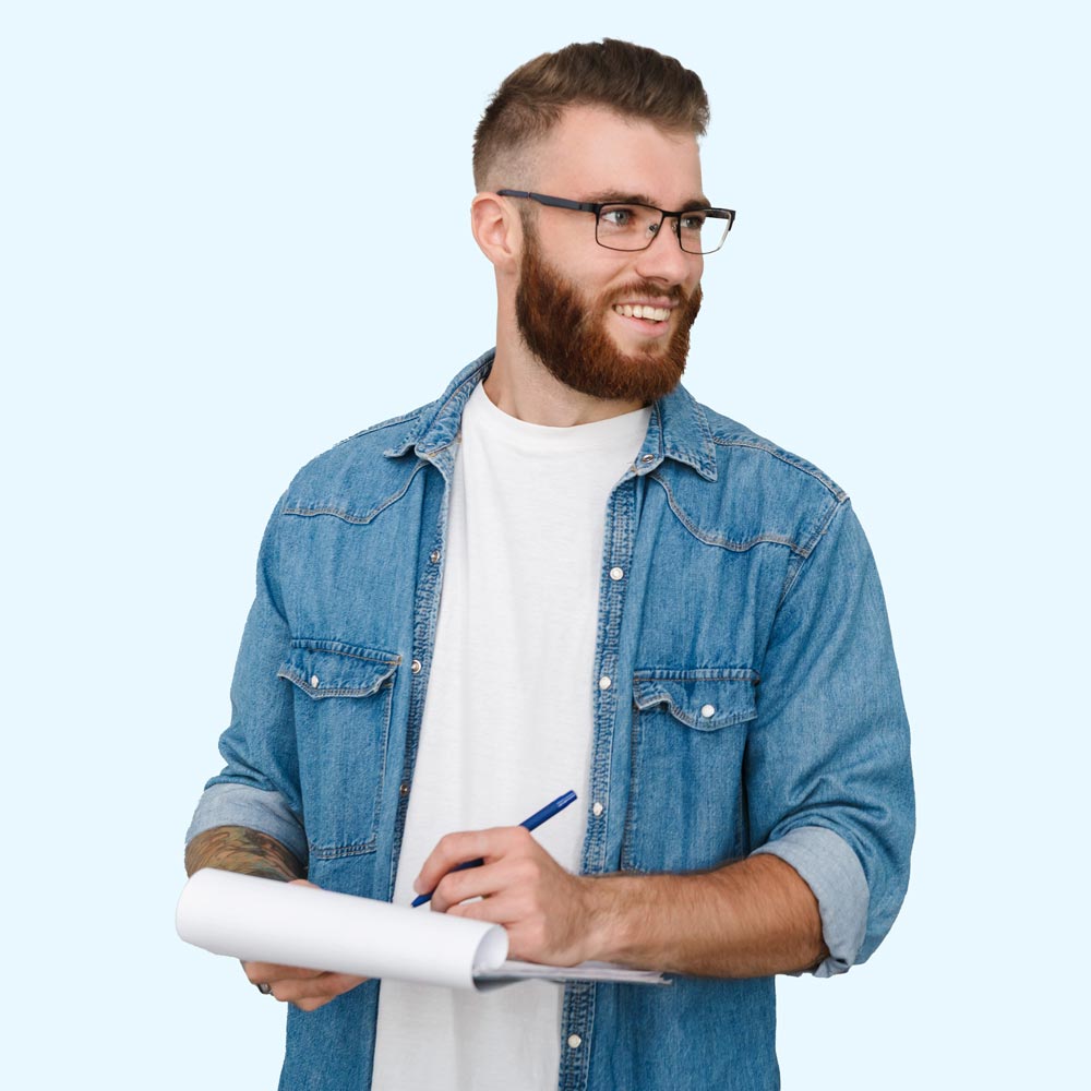 Young Adult Male Writing on Notepad